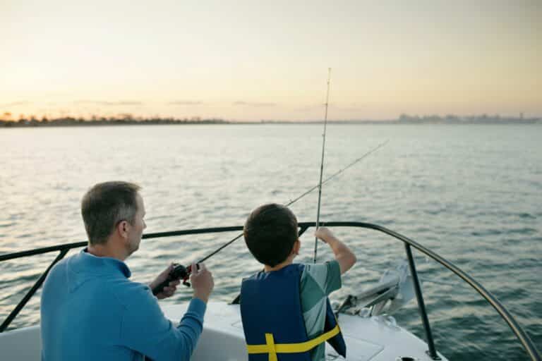 Father And Son Fishing On Boat